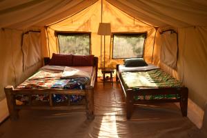 מיטה או מיטות בחדר ב-Red Rocks Rwanda - Campsite & Guesthouse