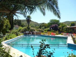 a swimming pool in a resort with mountains in the background at Hosteria Pastoral & Spa in La Cumbre