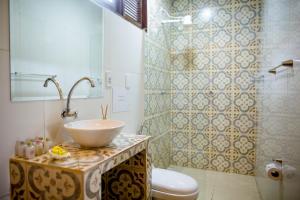 a bathroom with a sink and a toilet at Casa Bougainvilla in Jericoacoara +9 photos