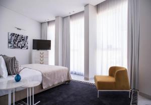 a bedroom with a large bed and a large window at 65 Hotel, Rothschild Tel Aviv - an Atlas Boutique Hotel in Tel Aviv