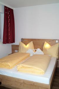 Voodi või voodid majutusasutuse Sieglhub Chalets - Appartements - Hotel toas