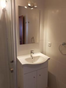 a bathroom with a white sink and a mirror at Páteo Badajoz in Sintra +25 photos