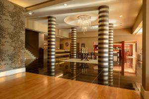 a living room with striped columns in a house at Congo Palace in Athens