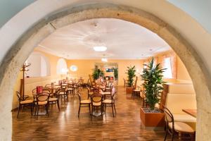 an arched hallway with tables and chairs in a restaurant at JUFA Hotel Wien City in Vienna