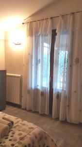 A bed or beds in a room at La Graziosa Dépendance