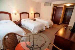 En eller flere senge i et værelse på Arapey Thermal All Inclusive Resort & Spa