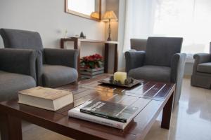 a living room with a table with books and chairs at Hotel Brisa in A Coruña