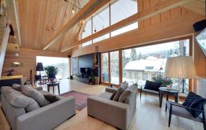 a living room with couches and a large window at Apartamenty Sun & Ski Willa Laser in Szklarska Poręba