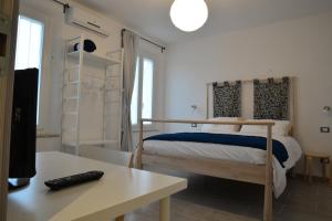a bedroom with a bed and a desk with a keyboard at Le stanze di LaVi in Ferrara
