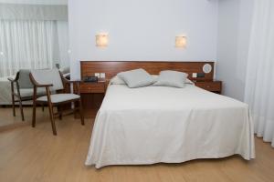 a bedroom with a bed and a desk and a chair at Hotel Brisa in A Coruña
