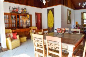 a dining room with a wooden table and chairs at Pousada Bela Cigana in Conservatória