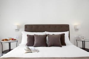Posteľ alebo postele v izbe v ubytovaní La Fontanina Suites