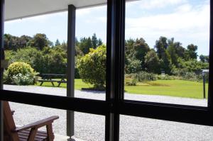 a view from a balcony overlooking a river at Heritage Park Lodge in Haast