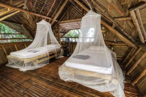 Postel nebo postele na pokoji v ubytování Kookoo's nest eco-lodge