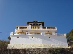 a large white building on top of a cliff at Aqua De Vida in Bhowāli