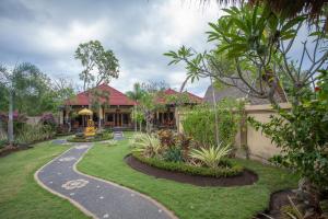 a house with a garden and a walkway at Taruna Boutique Homestay & Spa in Pemuteran