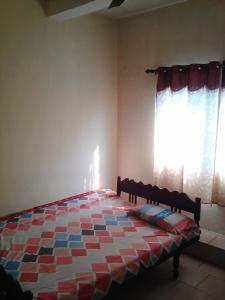 a bedroom with a bed in front of a window at St. Antonys Lodge in Cochin