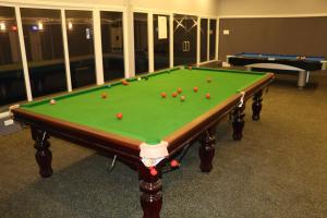 a pool table with balls on top of it at Bigstay in Tada