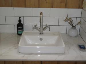 a white sink with a faucet on a counter at Nivani 1880's cottage in Port Fairy