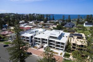 an aerial view of a city with a white building at Bluewater Apartments in Kiama