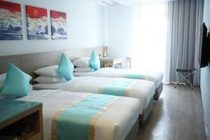 Katil atau katil-katil dalam bilik di Palau Hotel