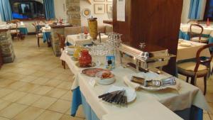 a table with plates of food on it at Hotel Triolet in Courmayeur