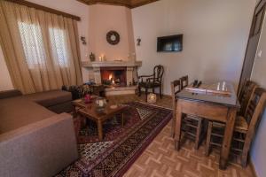 a living room with a couch and a table and a fireplace at Lampreiko in Synikia Mesi Trikalon