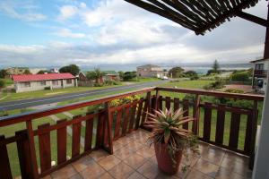 a balcony with a potted plant and a view of a street at Haus Giotto in Gansbaai