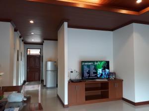 a living room with white walls and a refrigerator at BaanManchusa Thai Villa in Rawai Beach