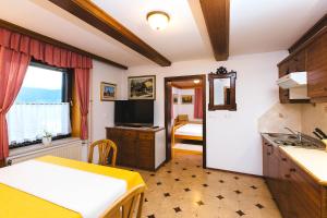 a kitchen with a sink and a table in a room at Apartments Dolar in Bled