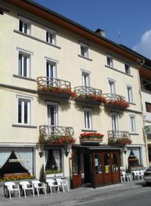 a large white building with tables and chairs in front of it at Hotel Juan Canejan in Les