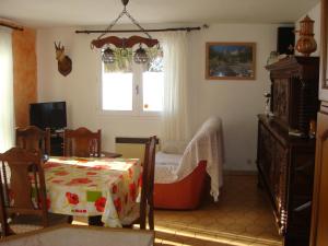 a living room with a bed and a window at La Grande Lauze in Champcella