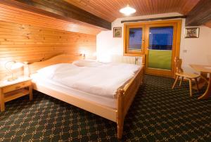 a bedroom with a large bed in a wooden room at Apartments Dolar in Bled