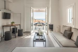 a living room with a couch and a table at Eneos Kythnos Beach Villas-Elegant and Comfort Villas in Kithnos