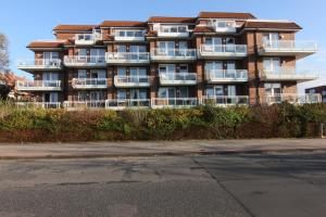 an apartment building with balconies on the side of a street at Residenz Albatros in Cuxhaven