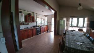 a kitchen with a table in the middle of it at casa de campo en Villa Los Aromos Cordoba in Villa Los Aromos