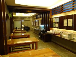 a restaurant with tables and counters in a room at Wuzhou Hotel in Hualien City