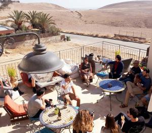 a group of people sitting on a patio at Yehelim Boutique Hotel in Arad