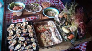 a table topped with trays of different types of food at Globertrotters in Castro