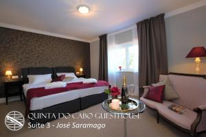 a hotel room with a bed and a couch at Quinta do Cabo Guesthouse in Sintra