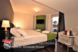 a hotel room with a bed and a window at Quinta do Cabo Guesthouse in Sintra