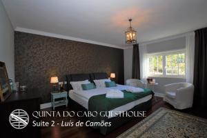 a hotel room with a bed and a chandelier at Quinta do Cabo Guesthouse in Sintra