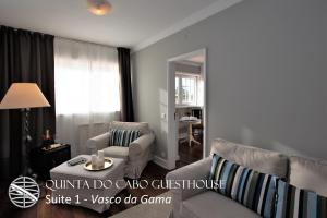 a living room with a couch and chairs and a table at Quinta do Cabo Guesthouse in Sintra