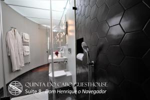 a shower with a glass door in a bathroom at Quinta do Cabo Guesthouse in Sintra