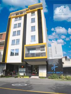 un edificio blanco y amarillo en una calle en Hotel Arthur Brich en Cúcuta