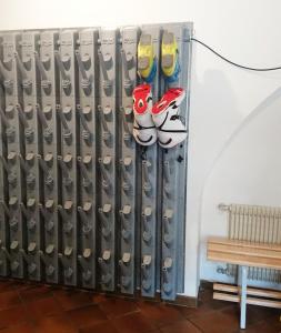 a iron radiator with shoes on it next to a bench at Hotel Nès Crépes in Pozza di Fassa