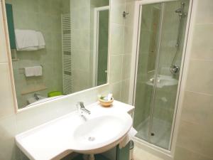a bathroom with a sink and a shower at Lido Resort in Finale Ligure