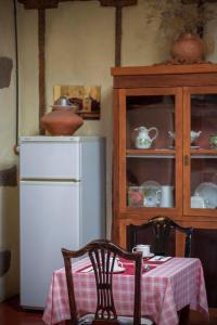 
a kitchen with a table and chairs and a refrigerator at Hotel Rural Orotava in La Orotava
