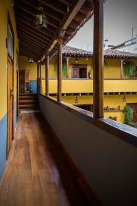 
a room with a wooden floor and a large window at Hotel Rural Orotava in La Orotava
