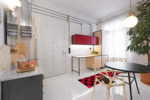 a kitchen with a table and chairs in a room at Trilogy Experimental in Thessaloniki